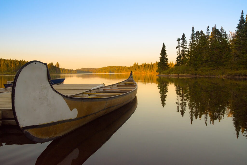 Canoe in a canadian lake of La Mauricie National Park at sunset